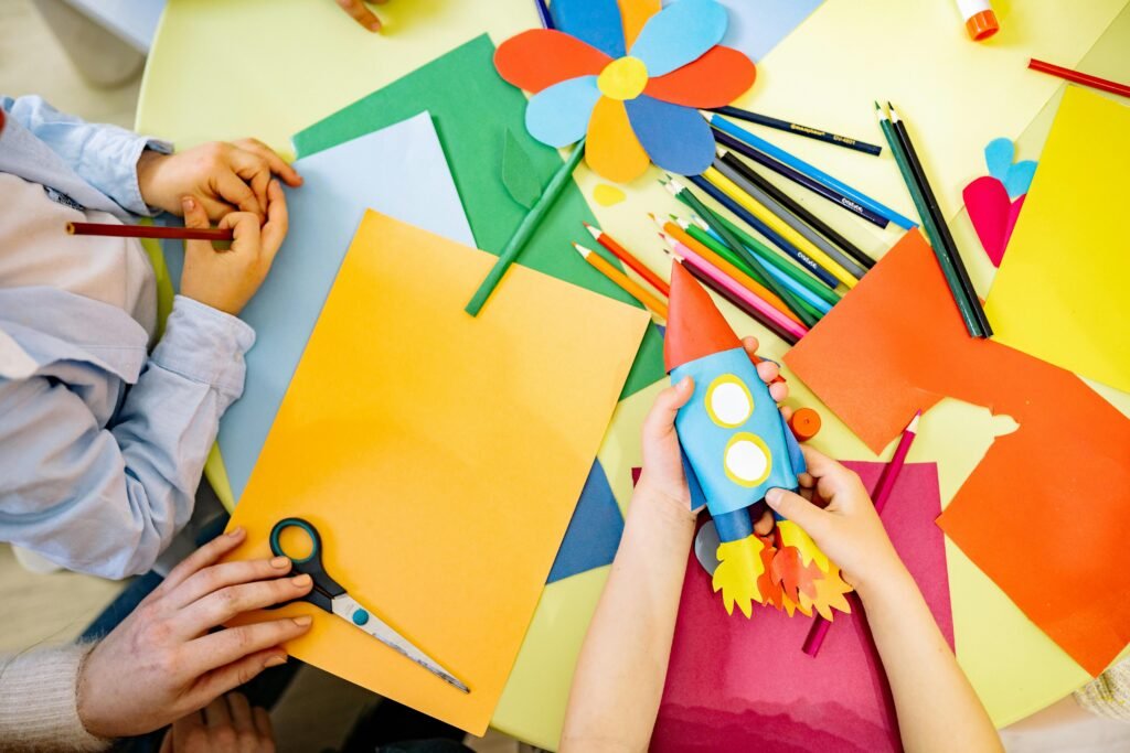 pexels-photo-8612992-8612992 Children engaged in a vibrant arts and crafts session with paper and pencils. Perfect for education and creativity themes.
